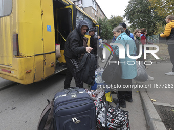 People from the Kupiansk community arrive at an evacuation point as mandatory evacuation from four communities in the Kharkiv region begins...