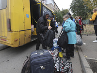 People from the Kupiansk community arrive at an evacuation point as mandatory evacuation from four communities in the Kharkiv region begins...