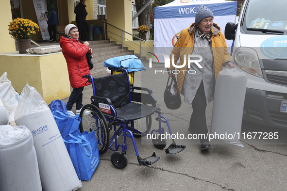 People from the Kupiansk community arrive at an evacuation point as mandatory evacuation from four communities in the Kharkiv region begins...