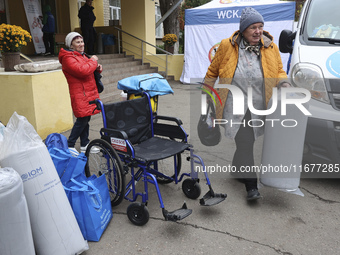 People from the Kupiansk community arrive at an evacuation point as mandatory evacuation from four communities in the Kharkiv region begins...