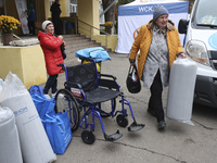 People from the Kupiansk community arrive at an evacuation point as mandatory evacuation from four communities in the Kharkiv region begins...