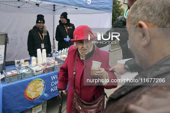 An elderly woman has a hot drink and biscuit at an evacuation point during the arrival of people from the Kupiansk community in Kharkiv, Ukr...