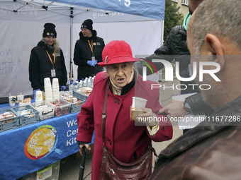 An elderly woman has a hot drink and biscuit at an evacuation point during the arrival of people from the Kupiansk community in Kharkiv, Ukr...