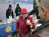 An elderly woman has a hot drink and biscuit at an evacuation point during the arrival of people from the Kupiansk community in Kharkiv, Ukr...