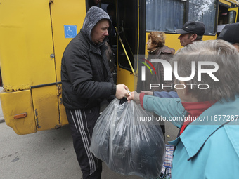 People from the Kupiansk community arrive at an evacuation point as mandatory evacuation from four communities in the Kharkiv region begins...