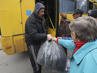 People from the Kupiansk community arrive at an evacuation point as mandatory evacuation from four communities in the Kharkiv region begins...