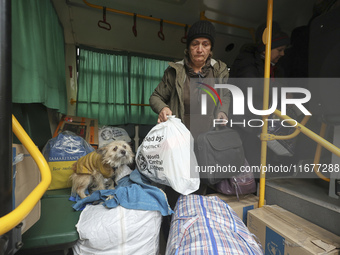 People from the Kupiansk community arrive at an evacuation point as mandatory evacuation from four communities in the Kharkiv region kicks o...