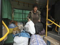 People from the Kupiansk community arrive at an evacuation point as mandatory evacuation from four communities in the Kharkiv region kicks o...