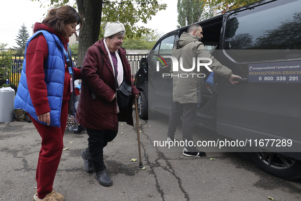 A volunteer accompanies an elderly woman at an evacuation point during the arrival of people from the Kupiansk community in Kharkiv, Ukraine...