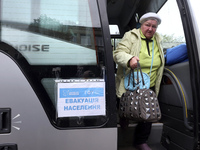 An elderly woman gets out of a bus at an evacuation point during the arrival of people from the Kupiansk community in Kharkiv, Ukraine, on O...