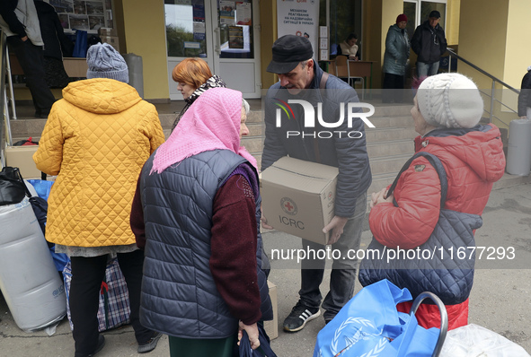 People from the Kupiansk community arrive at an evacuation point as mandatory evacuation from four communities in the Kharkiv region begins...