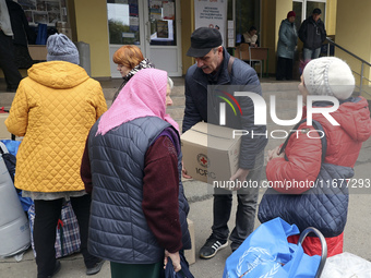 People from the Kupiansk community arrive at an evacuation point as mandatory evacuation from four communities in the Kharkiv region begins...