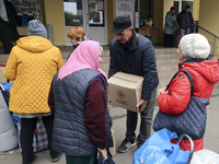 People from the Kupiansk community arrive at an evacuation point as mandatory evacuation from four communities in the Kharkiv region begins...