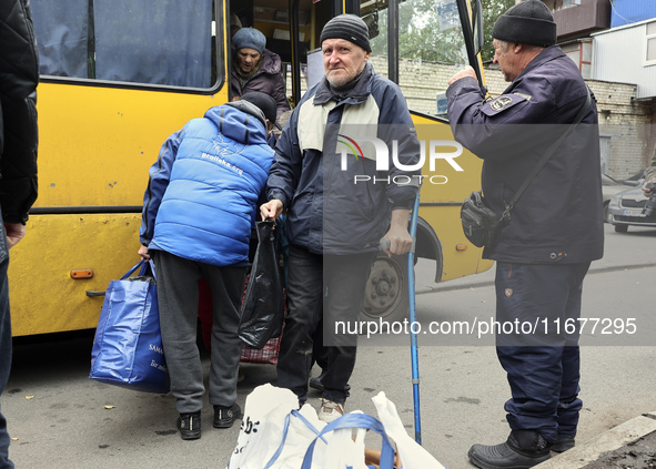 People from the Kupiansk community arrive at an evacuation point as mandatory evacuation from four communities in the Kharkiv region begins...