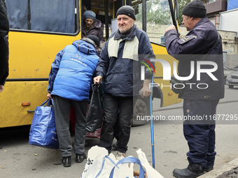 People from the Kupiansk community arrive at an evacuation point as mandatory evacuation from four communities in the Kharkiv region begins...