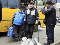 People from the Kupiansk community arrive at an evacuation point as mandatory evacuation from four communities in the Kharkiv region begins...