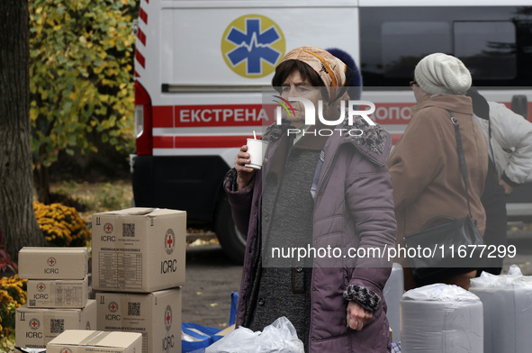 An elderly woman has a hot drink at an evacuation point during the arrival of people from the Kupiansk community in Kharkiv, Ukraine, on Oct...