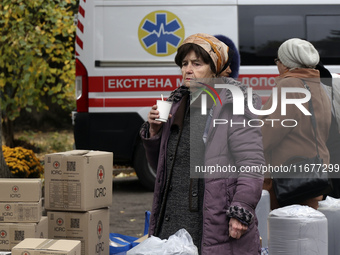 An elderly woman has a hot drink at an evacuation point during the arrival of people from the Kupiansk community in Kharkiv, Ukraine, on Oct...