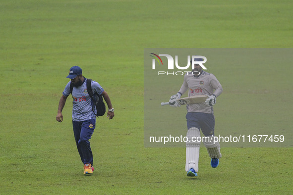 Bangladeshi cricketer Liton Das (R) attends a practice session at the Sher-e-Bangla National Cricket Stadium in Dhaka, Bangladesh, on Octobe...