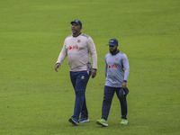 Bangladeshi cricket team head coach Phil Simmons (L) participates in a practice session at the Sher-e-Bangla National Cricket Stadium in Dha...