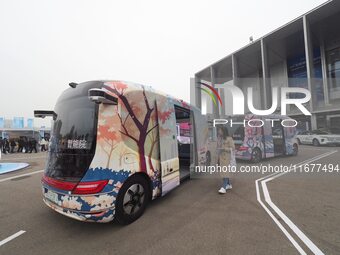 Viewers visit autonomous vehicles at the 2024 World Intelligent Connected Vehicle Conference in Beijing, China, on October 18, 2024. (