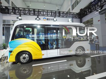 The audience visits the integrated autonomous driving bus at the 2024 World Intelligent Connected Vehicle Conference in Beijing, China, on O...