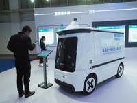 The audience visits the integrated unmanned delivery vehicle at the 2024 World Intelligent Connected Vehicle Conference in Beijing, China, o...