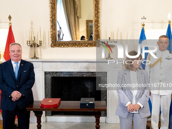 Grand Master and head of the Sovereign Military Order of Malta, Fra' John Timothy Dunlap (L), and Greek President Katerina Sakellaropoulou (...