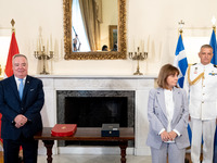 Grand Master and head of the Sovereign Military Order of Malta, Fra' John Timothy Dunlap (L), and Greek President Katerina Sakellaropoulou (...