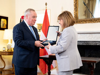 Grand Master and head of the Sovereign Military Order of Malta, Fra' John Timothy Dunlap (L), and Greek President Katerina Sakellaropoulou (...