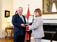 Grand Master and head of the Sovereign Military Order of Malta, Fra' John Timothy Dunlap (L), and Greek President Katerina Sakellaropoulou (...