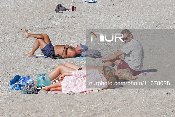 People enjoy the warm weather in Athens, Greece, on October 18, 2024. 