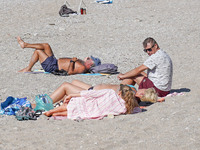 People enjoy the warm weather in Athens, Greece, on October 18, 2024. (