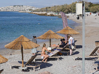 People enjoy the warm weather in Athens, Greece, on October 18, 2024. (