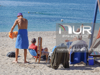 People enjoy the warm weather in Athens, Greece, on October 18, 2024. (