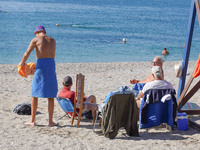 People enjoy the warm weather in Athens, Greece, on October 18, 2024. (