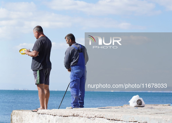 Fishermen experience warm weather in Athens, Greece, on October 18, 2024. 