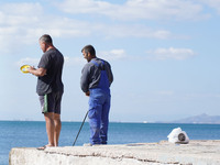 Fishermen experience warm weather in Athens, Greece, on October 18, 2024. (