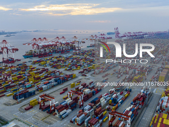 A photo taken in Shanghai, China, on October 18, 2024, shows the operation scene of the Yangshan Deep Water Port area of Shanghai Port. From...