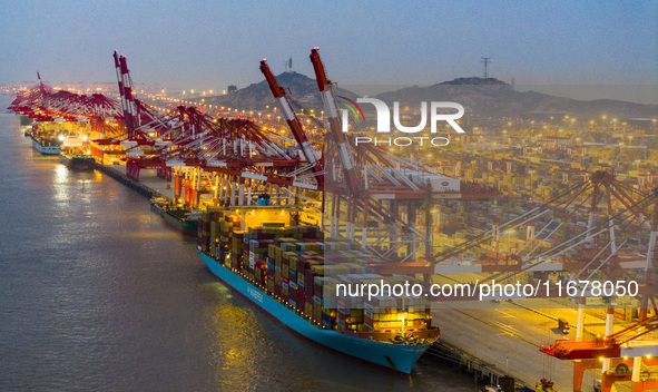 A photo taken in Shanghai, China, on October 18, 2024, shows the operation scene of the Yangshan Deep Water Port area of Shanghai Port. From...