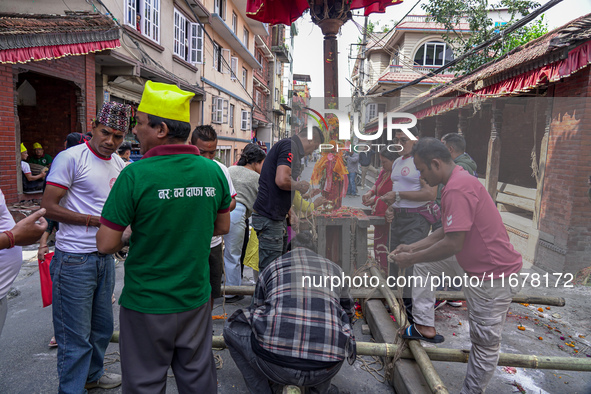 Nepalese Hindu devotees carry the chariot of Lord Satya Narayan during the Hadigaun Jatra festival in Kathmandu, Nepal, on October 18, 2024....