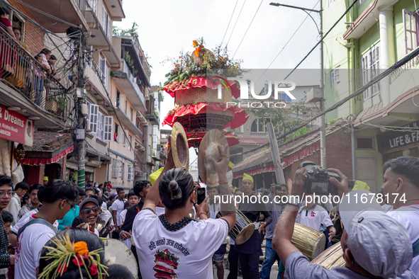 Nepalese Hindu devotees carry the chariot of Lord Satya Narayan during the Hadigaun Jatra festival in Kathmandu, Nepal, on October 18, 2024....