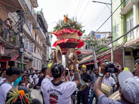 Nepalese Hindu devotees carry the chariot of Lord Satya Narayan during the Hadigaun Jatra festival in Kathmandu, Nepal, on October 18, 2024....