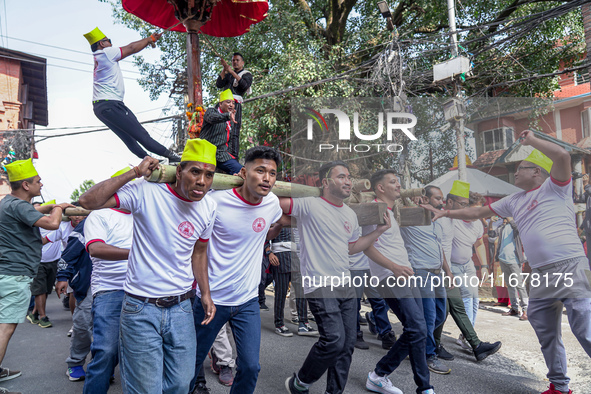 Nepalese Hindu devotees carry the chariot of Lord Satya Narayan during the Hadigaun Jatra festival in Kathmandu, Nepal, on October 18, 2024....