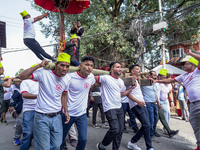 Nepalese Hindu devotees carry the chariot of Lord Satya Narayan during the Hadigaun Jatra festival in Kathmandu, Nepal, on October 18, 2024....