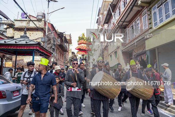 Nepalese Hindu devotees carry the chariot of Lord Satya Narayan during the Hadigaun Jatra festival in Kathmandu, Nepal, on October 18, 2024....