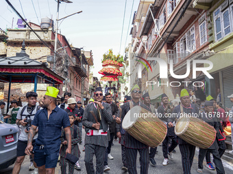 Nepalese Hindu devotees carry the chariot of Lord Satya Narayan during the Hadigaun Jatra festival in Kathmandu, Nepal, on October 18, 2024....