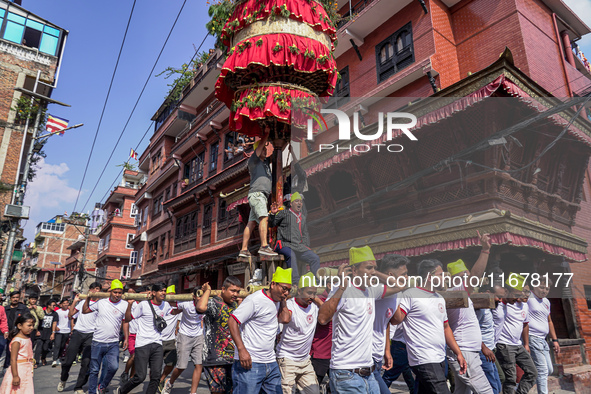 Nepalese Hindu devotees carry the chariot of Lord Satya Narayan during the Hadigaun Jatra festival in Kathmandu, Nepal, on October 18, 2024....