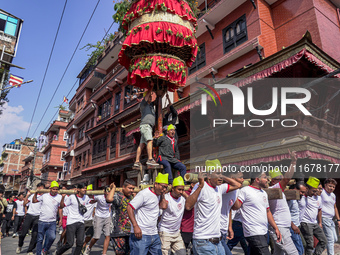 Nepalese Hindu devotees carry the chariot of Lord Satya Narayan during the Hadigaun Jatra festival in Kathmandu, Nepal, on October 18, 2024....