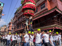 Nepalese Hindu devotees carry the chariot of Lord Satya Narayan during the Hadigaun Jatra festival in Kathmandu, Nepal, on October 18, 2024....